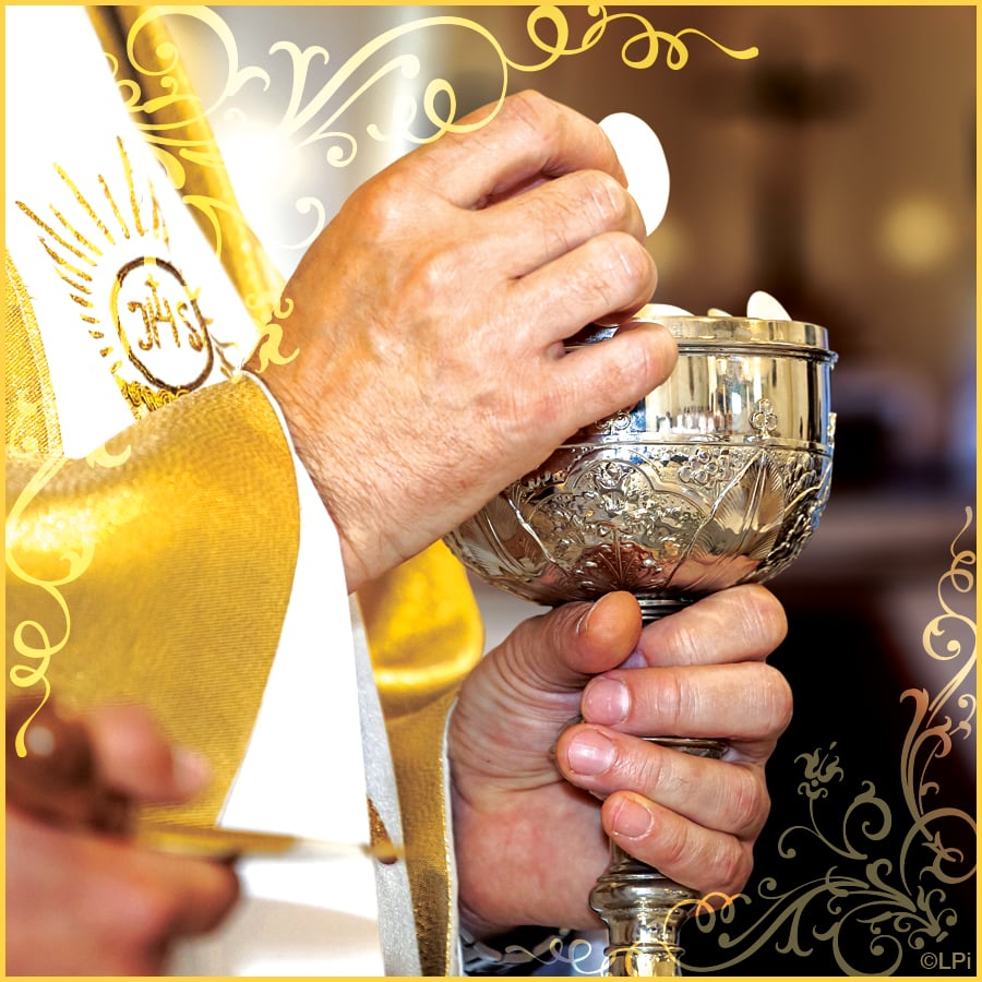 Photo of priest holding the chalice and host