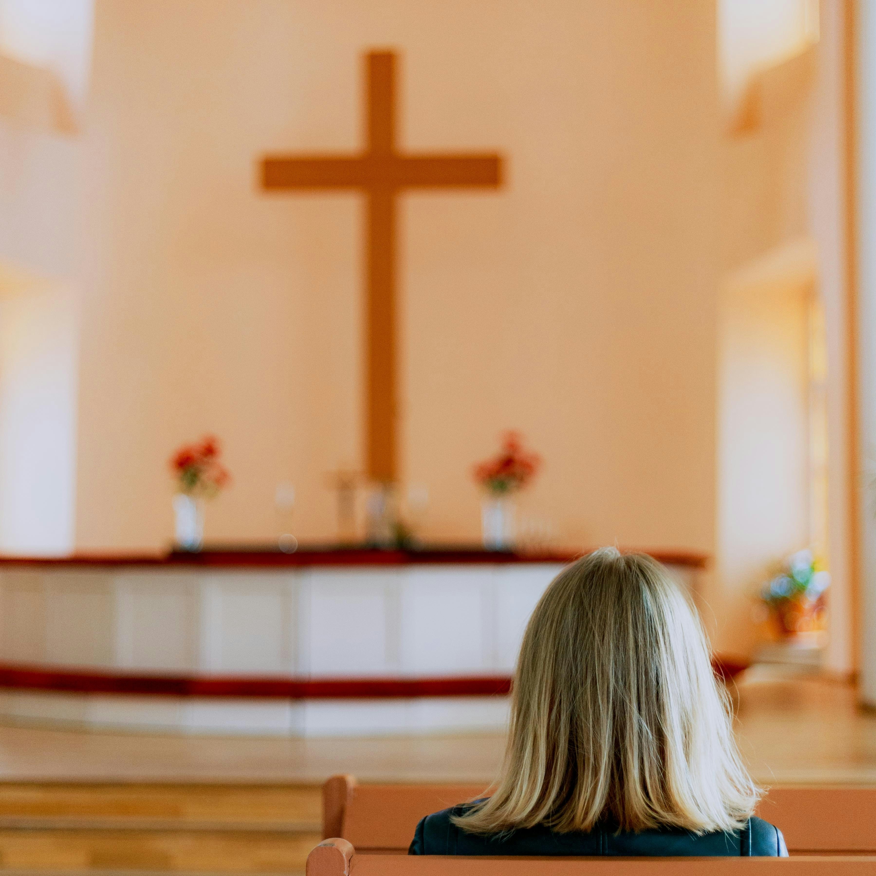 Photo of a woman seated in a church pew